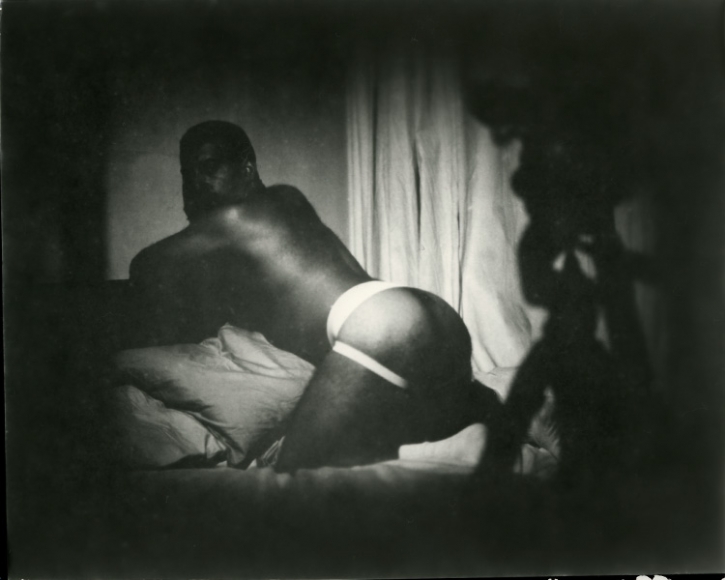 Man in jockstrap on bed by Benjamin Fredrickson
