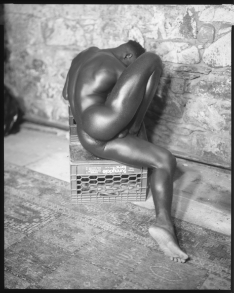 Man on milk crate by Benjamin Fredrickson
