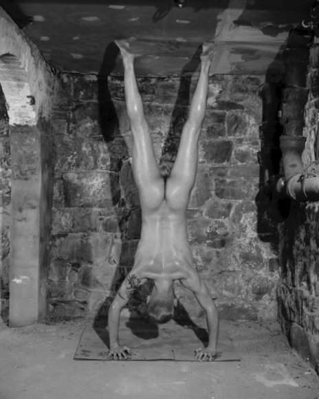 Man doing handstand by Benjamin Fredrickson
