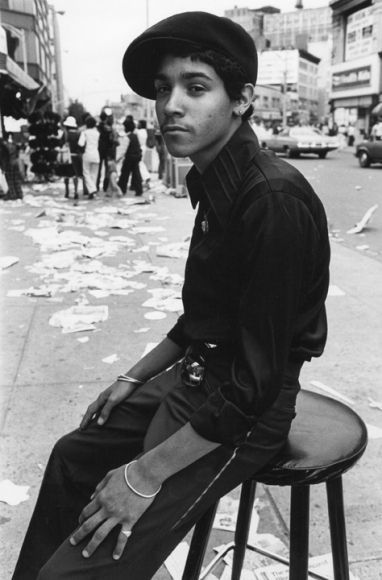 Man sitting on stool by Arlene Gottfried