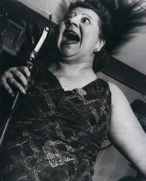 Lisette Model - Singer at Café Metropole, c. 1946 Gelatin silver print, 19 3/8 x 15 1/2 inches ; Bruce Silverstein Gallery