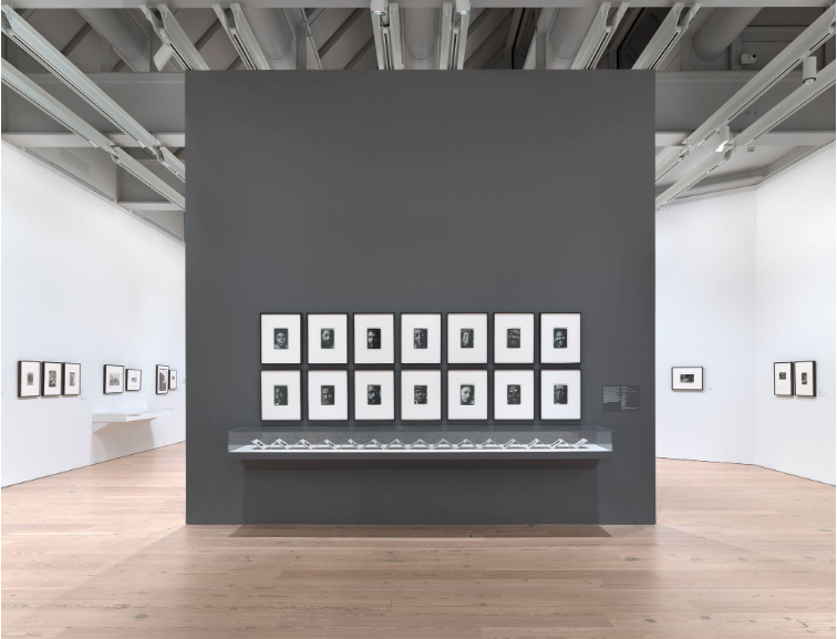 Installation view of Working Together: The Photographers of the Kamoinge Workshop (Whitney Museum of American Art, New York, November 21, 2020–March 28, 2021). Left wall, from left to right: Anthony Barboza, Ming Smith, NYC, 1973; Al Fennar, Sag Harbor, 1975; Al Fennar, Straight Street, 1965; Herb Robinson, Relaxing in Central Park, 1961; Herb Robinson, The Girls, 1969; Ming Smith, Sun Breeze after the Bluing, Hoboken, New Jersey, c. 1972; Ming Smith, Kites Inside, Columbus, Ohio, c. 1972. Middle wall, clockwise from top left: Anthony Barboza, Self Portrait (Anthony Barboza), 1972; Anthony Barboza, Adger Cowans, 1972; Anthony Barboza, Dan Dawson, 1972; Anthony Barboza, Louis Draper, 1972; Anthony Barboza, Al Fennar, 1972; Anthony Barboza, Ray Francis, 1972; Anthony Barboza, Herman Howard, 1972; Anthony Barboza, Calvin Wilson, 1972; Anthony Barboza, Shawn Walker, 1972; Anthony Barboza, Ming Smith, 1972; Anthony Barboza, Beuford Smith, 1972; Anthony Barboza, Herb Robinson, 1972; Anthony Barboza, Herbie Randall, 1972; Anthony Barboza, Jimmie Mannas, 1972; Vitrine: Anthony Barboza, Kamoinge Artists’ Book, 1972. Right wall, from left to right: C. Daniel Dawson, Grandma Thomas, 1968; Shawn Walker, Boy with Banana by the Window, Bronx, NY, 1966; Shawn Walker, Harlem, 117th Street, c. 1960. Photograph by Ron Amstutz
