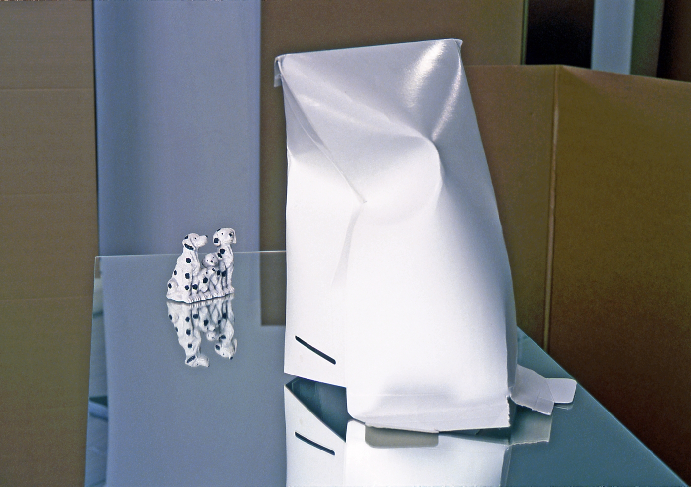 Untitled, 2001, Mirror pedestal, Dalmatians, gallery envelope, and artist tape, 54 x 32 x 18 inches