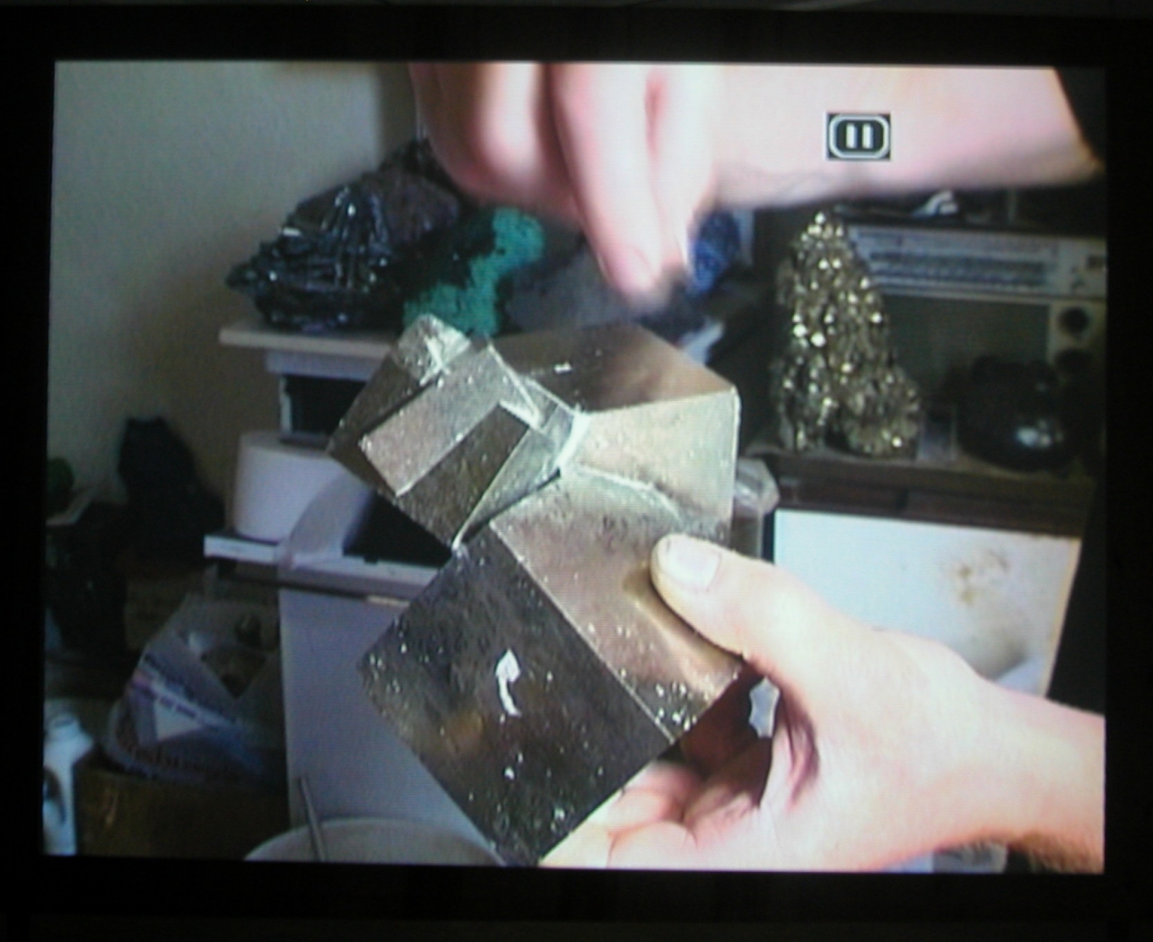 Quarry, 2003 (still), Two Parts: “Blast” (4 minutes), “Dr. Chris Alabaster” (12 minutes), 2 DVDs, bleachers, wooden screen, Installation dimensions variable