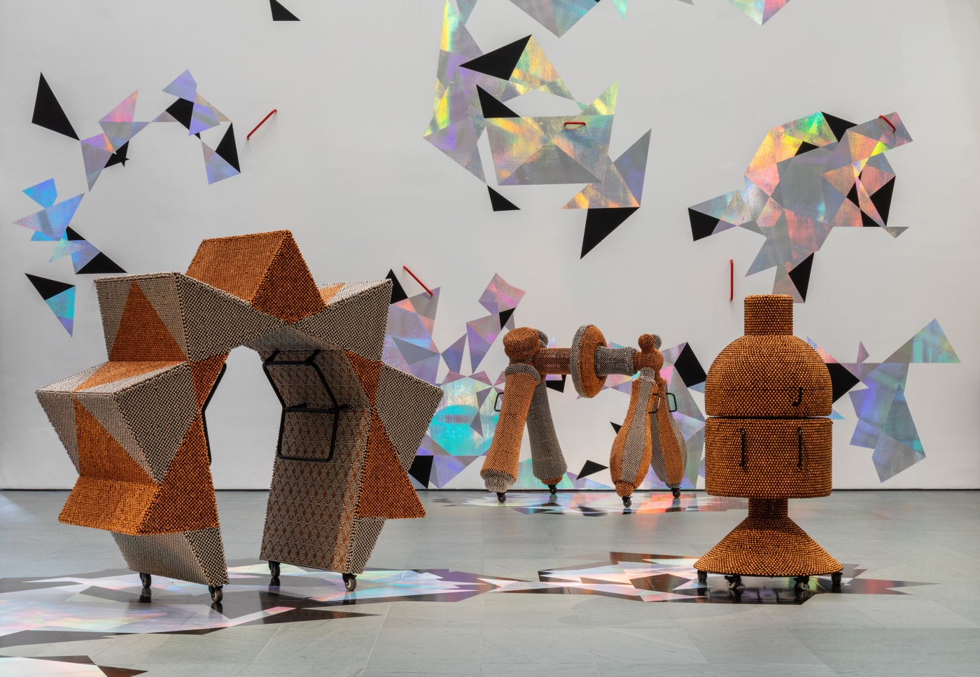 Haegue Yang (Korean, b. 1971) is known for genre-defying, multimedia installations that interweave a range of materials and methods, historical references, and sensory experiences. Handles, Yang’s installation commissioned for MoMA’s Marron Atrium, features six sculptures activated daily, dazzling geometries, and the play of light and sound, to create a ritualized, complex environment with both personal and political resonance., 