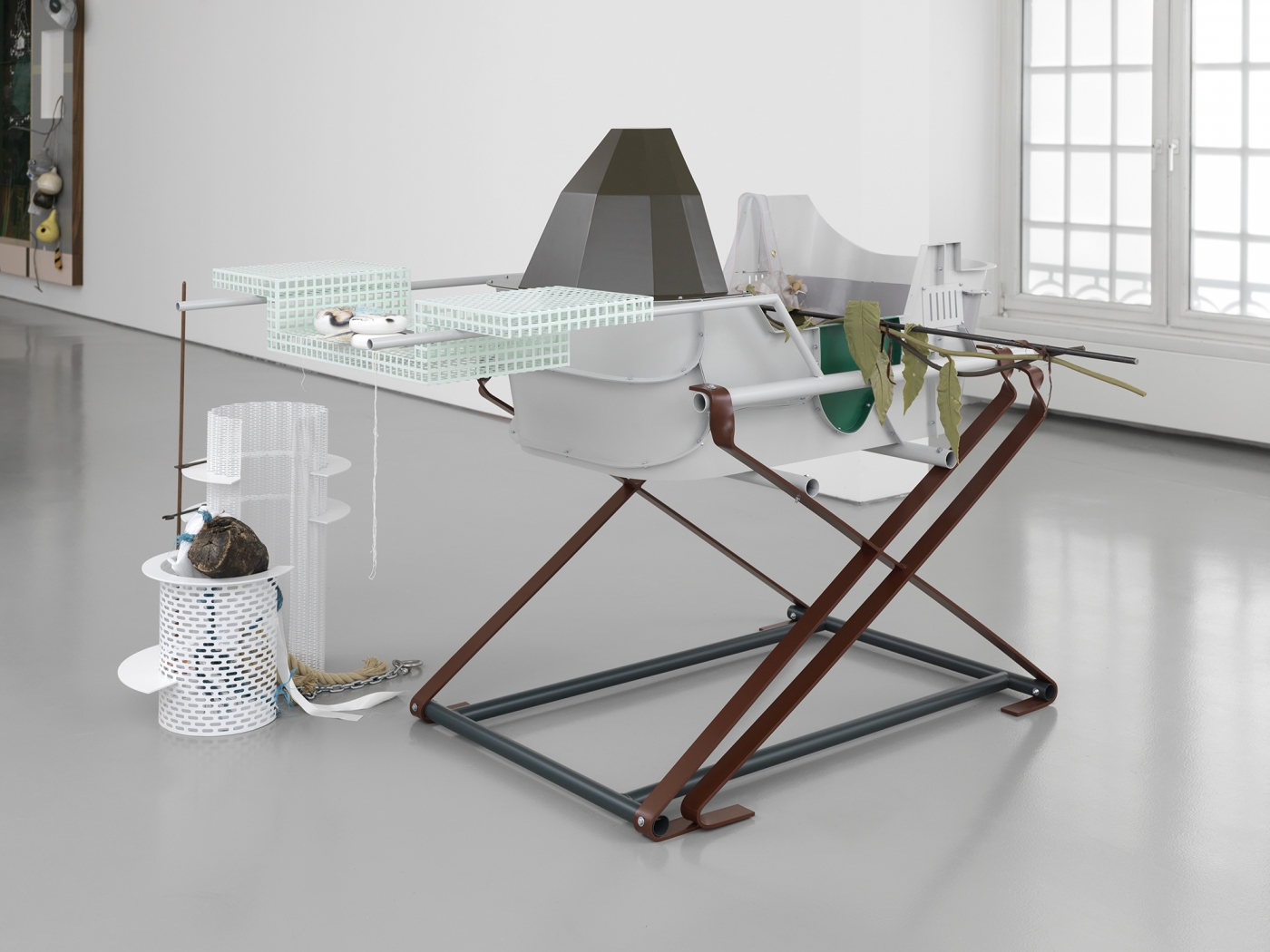 Helen Marten Becoming branch, 2014 Welded steel, stitched fabric, plastic, cast rubber, airbrushed wood, tree stump, rope, walnut, truck tyre, burnt bark, glass marble, string 57 x 67 x 41 1⁄3 in (144.78 x 170.18 x 110.07 cm)