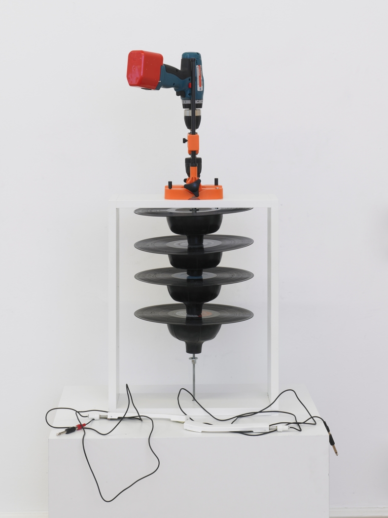 Tony Conrad Pharmonica, 2012 Drill, pipe, drill press, metal mounting flange, 4 12-inch records, plunger heads, band clamps 36 5/8 x 16 1/2 x 15 3/4 inches 93 x 42 x 40 cm