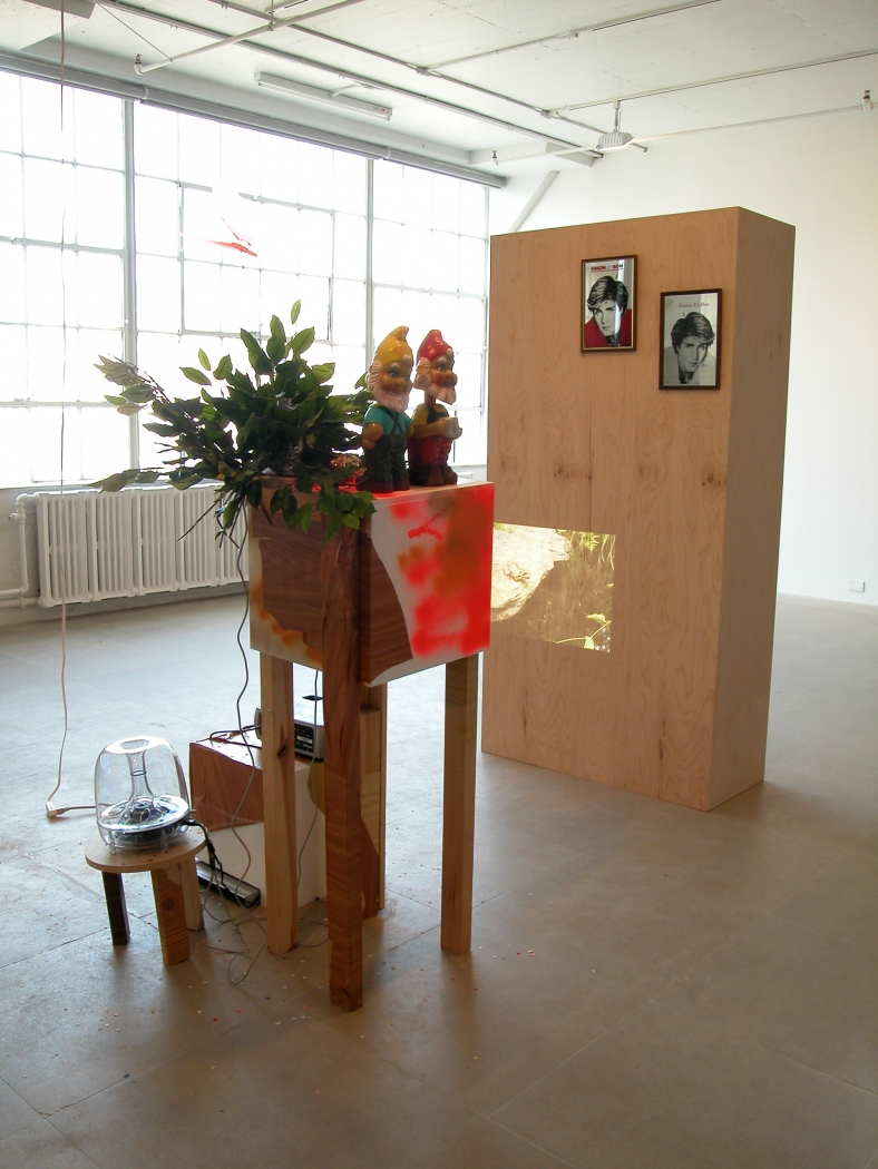 Rachel Harrison, Double Vision, 2006-2008, wood, shelf liner, metal, plastic, fake foliage, confetti, DVD player, projector, apple sound sticks, Simon LeBon mirrors, 78 x 36 x 18 inches