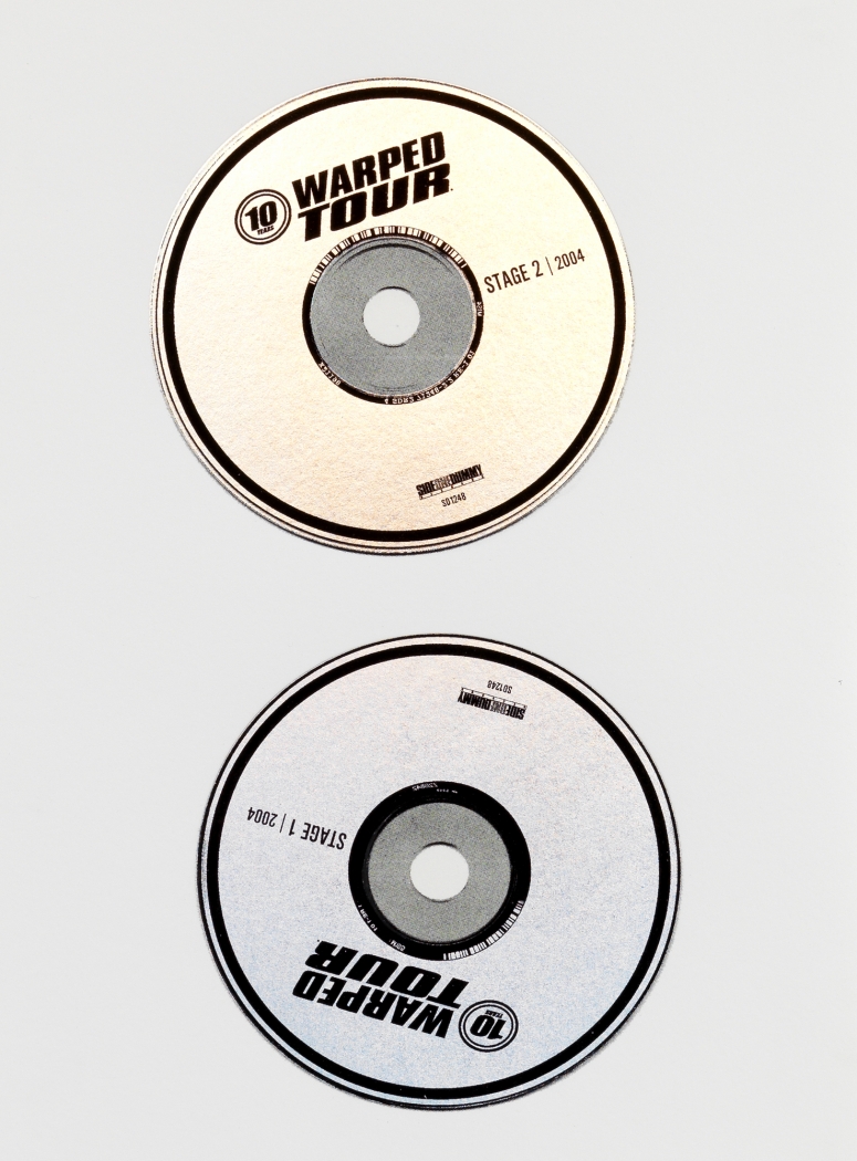 Two silver CD's with black border arranged vertically that read "Warped Tour, 2004" and "Stage 2" and "Stage 1", respectively.