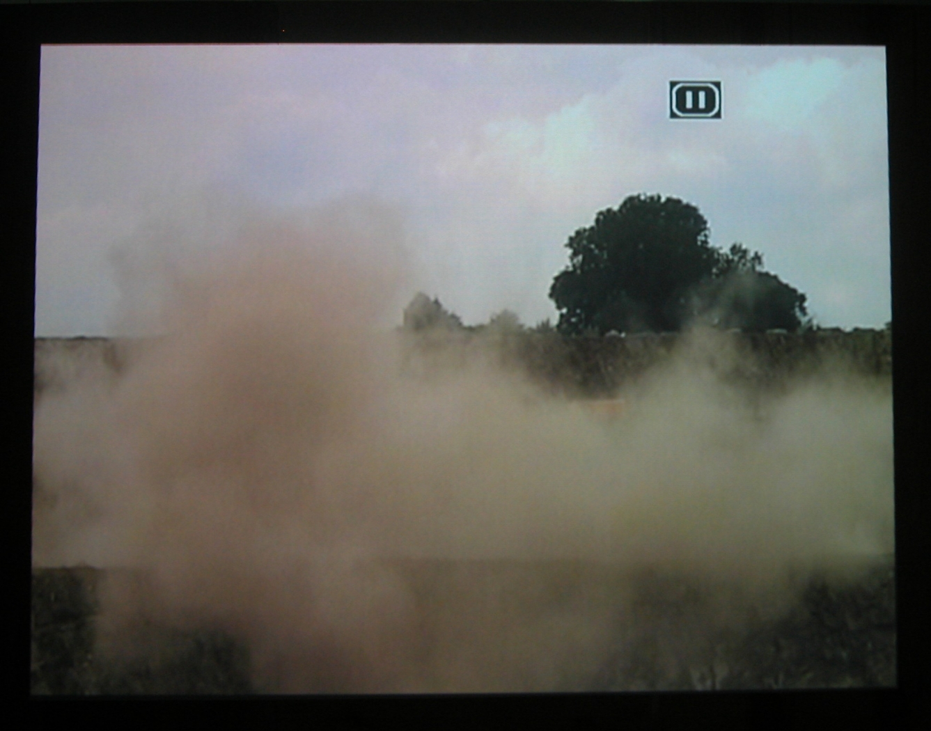 Quarry, 2003 (still), Two Parts: “Blast” (4 minutes), “Dr. Chris Alabaster” (12 minutes), 2 DVDs, bleachers, wooden screen, Installation dimensions variable
