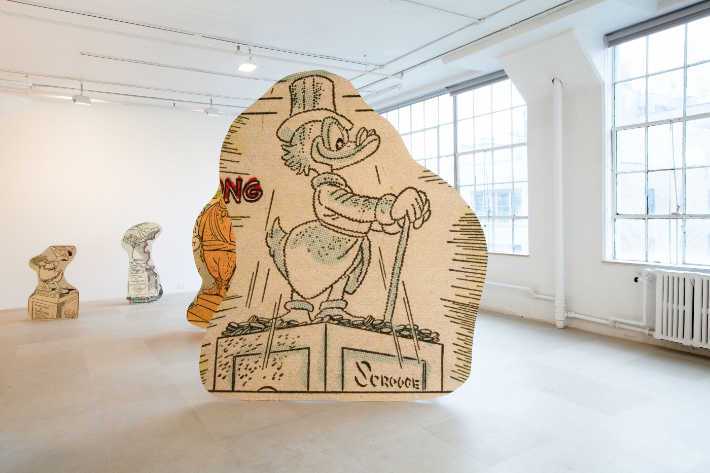 Allen Ruppersberg, Big Trouble, 2010, 10 framed pigment prints on paper with cutouts (each 30 5/8 x 22 inches) and 15 standing sculptures: pigment prints on paper mounted to AB marine-grade plywood, overall dimensions variable, Installation view, Greene Naftali, New York, 2010