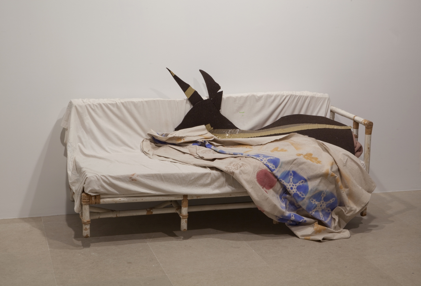 Gedi Sibony (with Diana Lyon), Who Attracts All That is Named, 2010, couch, bed sheet, wool blanket, felt, tape, canvas and spraypaint, dimensions variable
