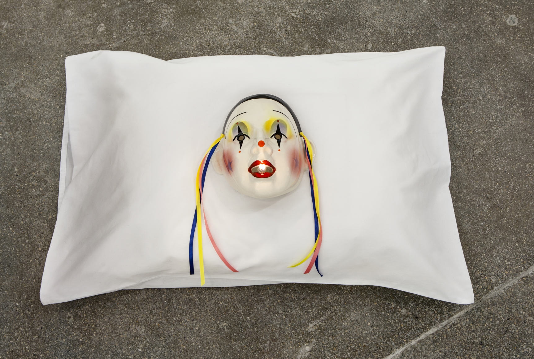 Jamie IsensteinFire in the Mouth, 2015Pillow, mask, oil lamp6 x 29 x 20 in (15.2 x 73.7 x 50.8 cm) 