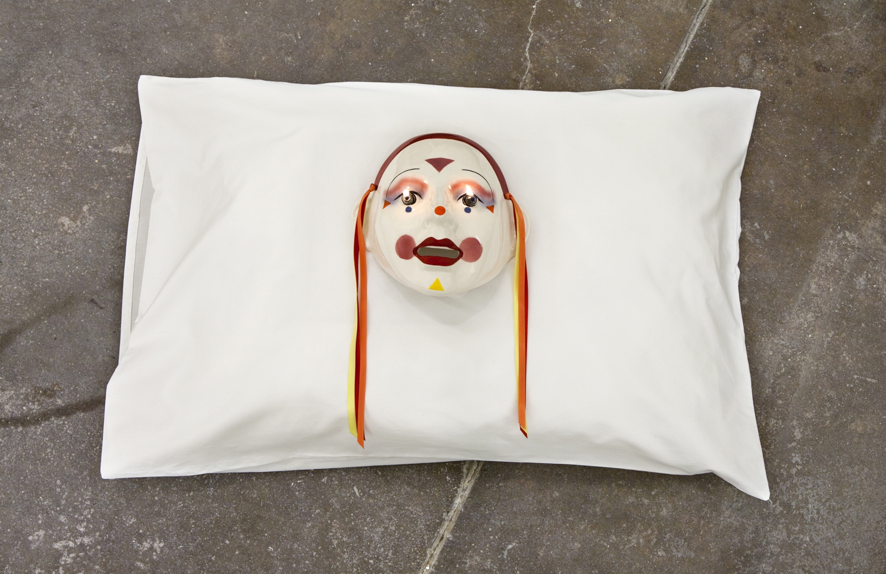 Jamie IsensteinFire in the Eyes, 2015Pillow, mask, oil lamp6 x 29 x 20 in (15.2 x 73.7 x 50.8 cm) 