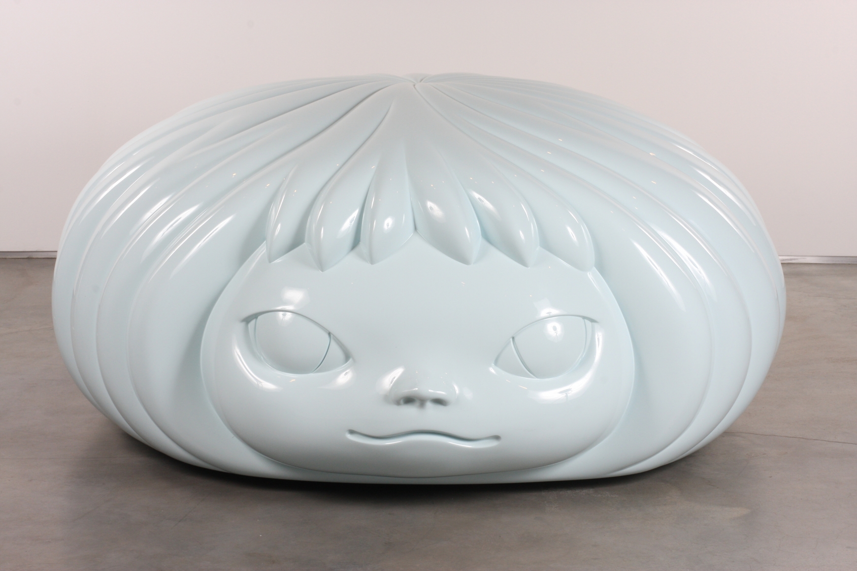 sculpture of a flat female head by yoshimoto nara