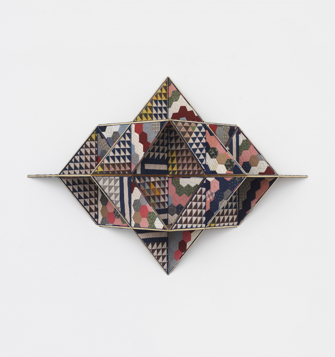 a geometric sculpture made of quilts by the artist Sanford Biggers