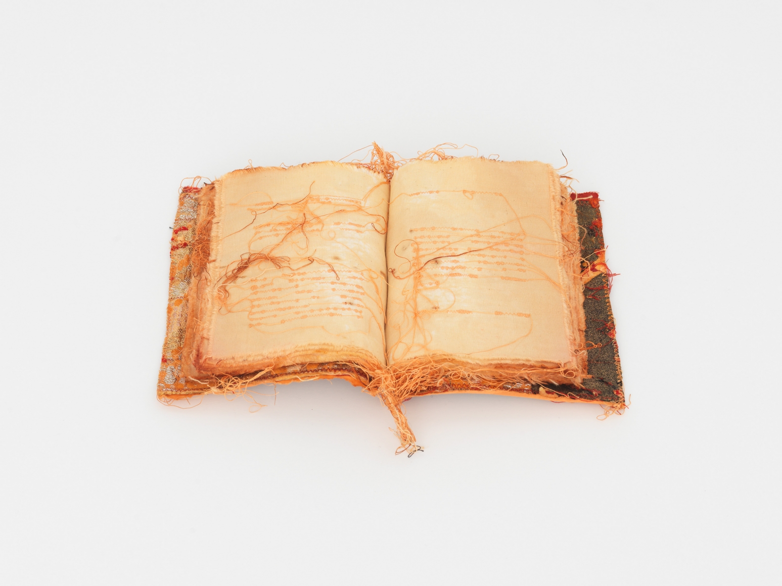 an embroidered book by italian female artist maria lai