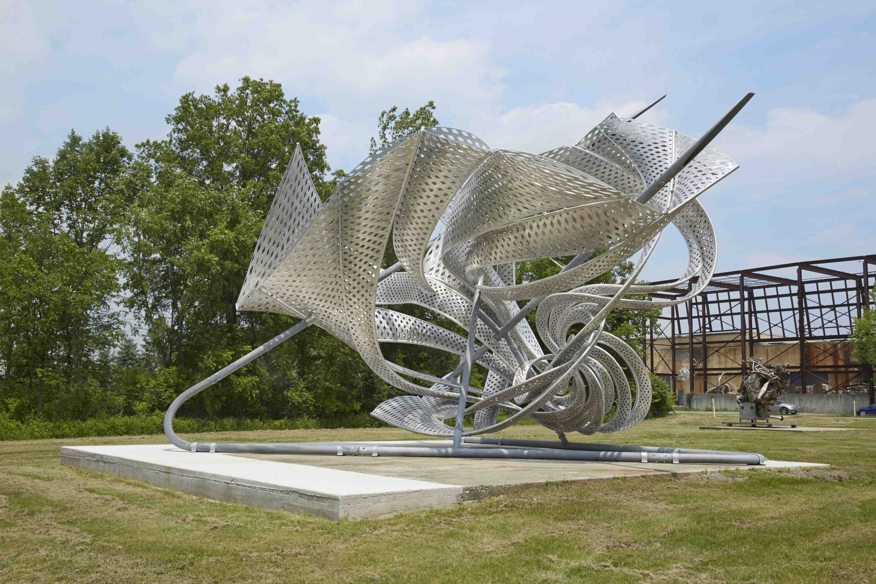 a twisted metal sculpture placed outside near frank stella's studio