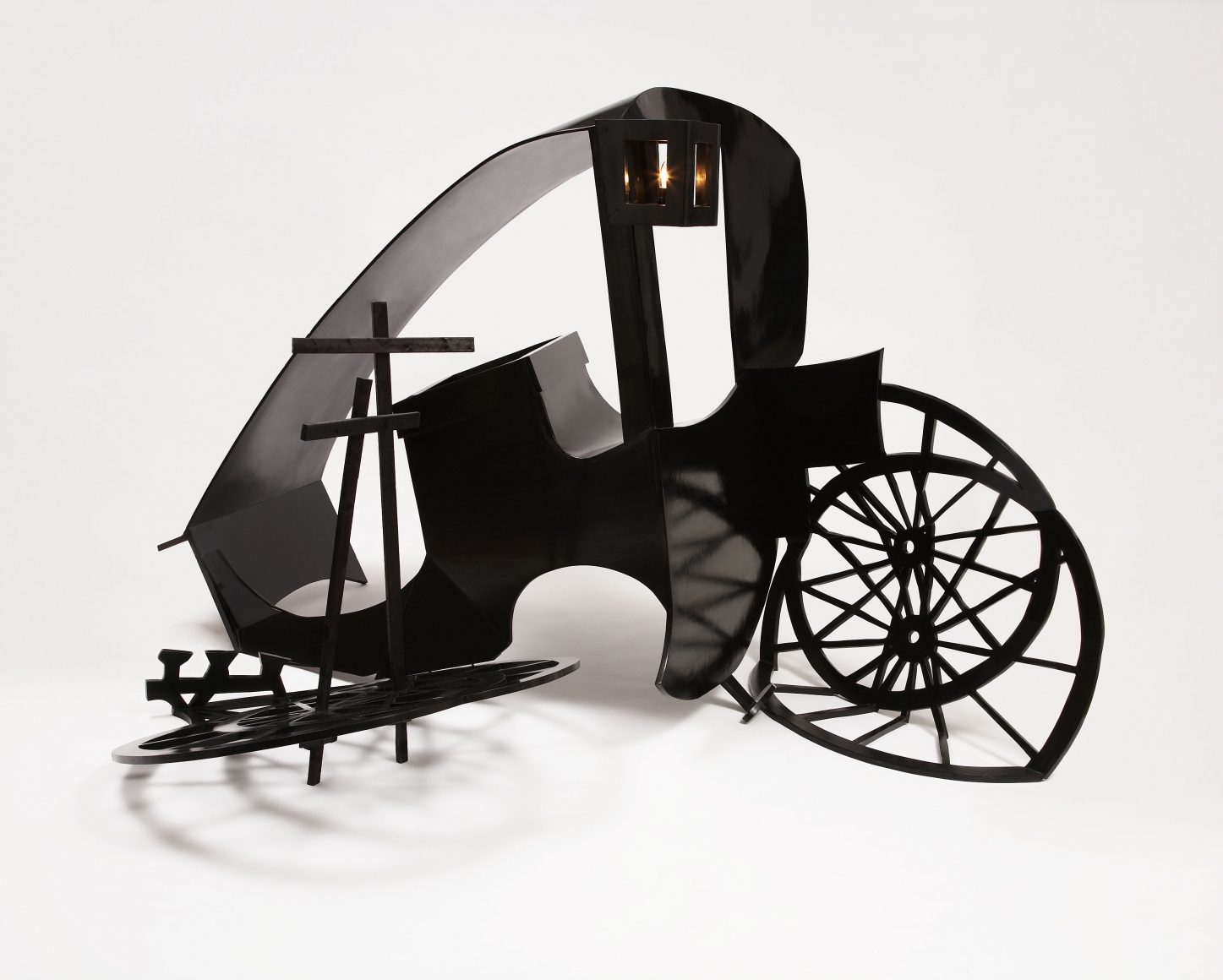 sculpture of a broken black coach by rachel feinstein