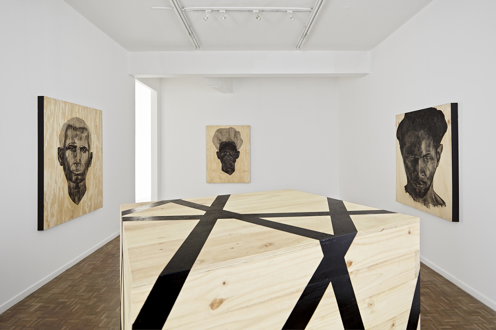 portraits of men painted on wood by serge alain nitegeka