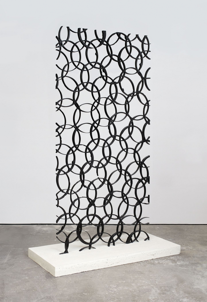 anthony pearson's steel sculpture of overlapping circles shown at an angle