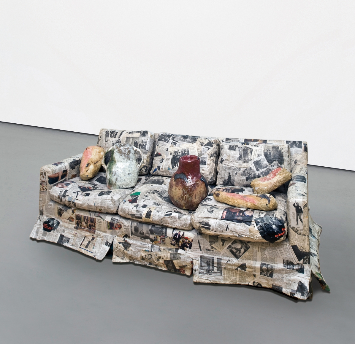 a sofa with ceramic artworks on it by jessica jackson hutchins for sale in an art gallery