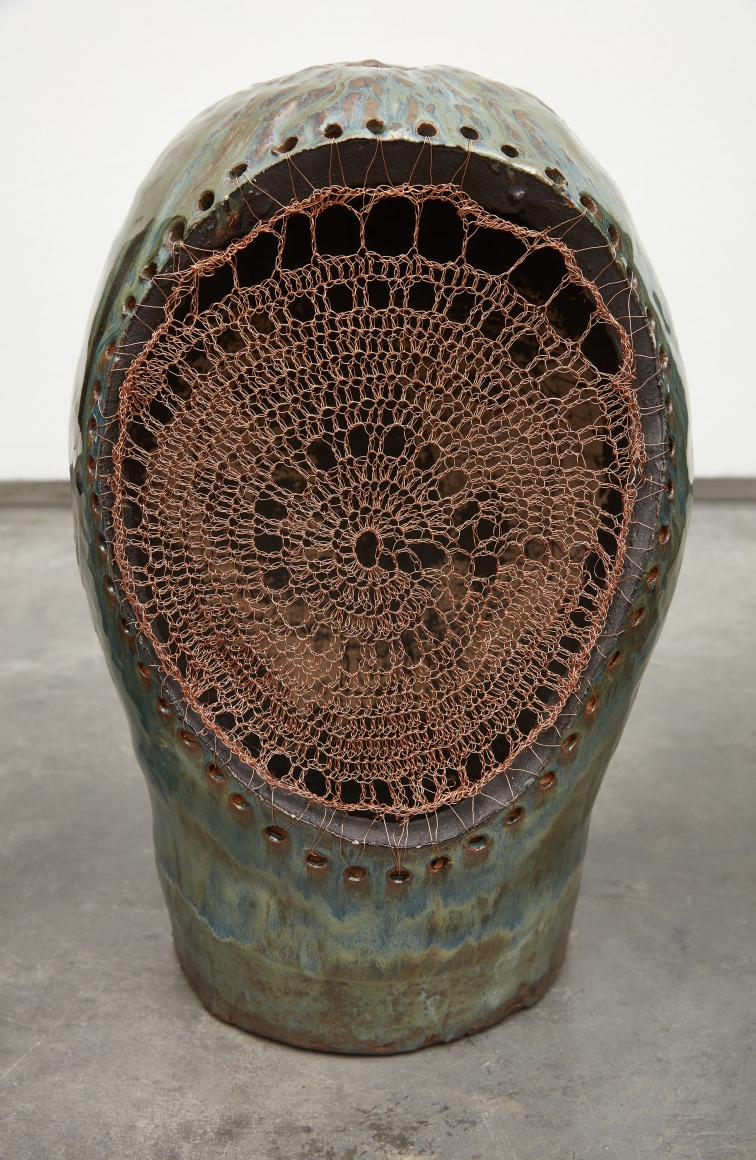 Ceramic work resembling a human head with intricate woven copper wire by ektor garcia