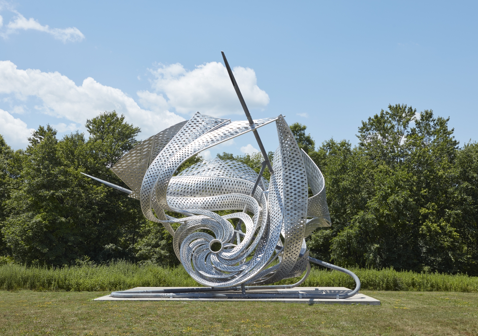 a twisted metal sculpture outdoors by frank stella