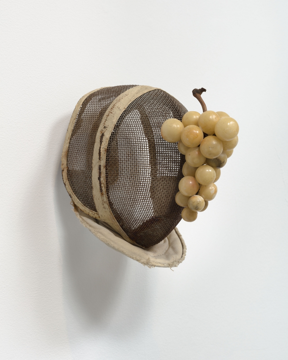 Allison Janae Hamilton, Fencing mask with alabaster grapes, 2019, Vintage fencing mask, stone grapes, natural grapevine