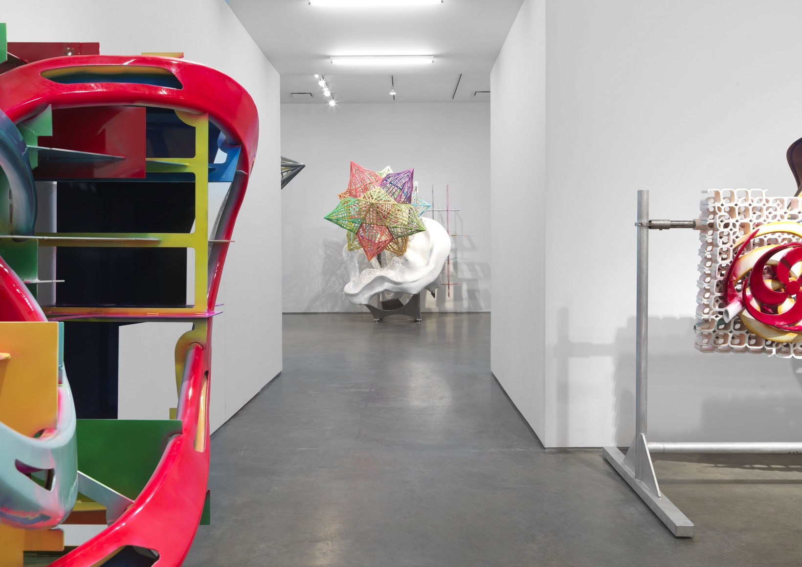 A star sculpture down a gallery hallway for a Frank STella exhibition