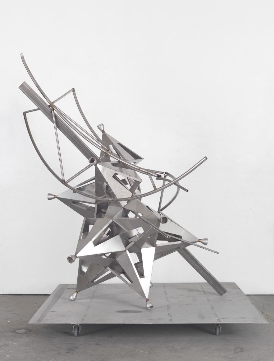 a deconstructed star sculpture of metal by Frank Stella in a chelsea contemporary art gallery
