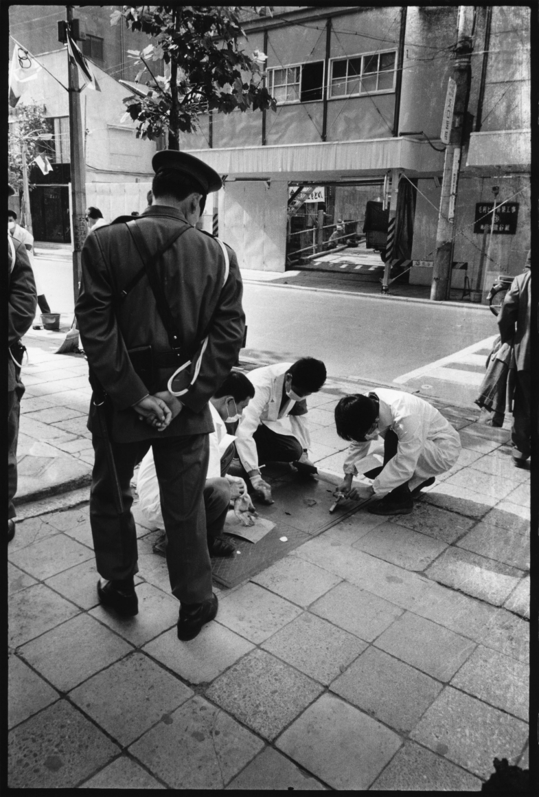 photo of people cleaning the street by minoru hirata