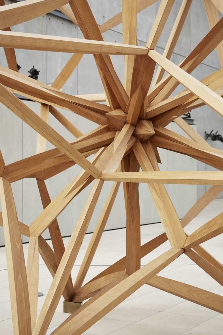 A detail of a wooden star made out of teak by frank stella