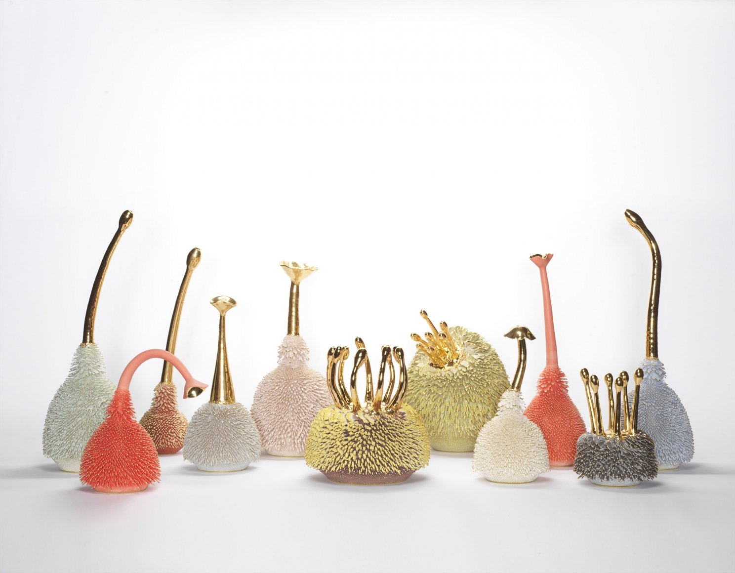 Group of multicolored porcelain sculptures with gold accents by the artists the haas brothers