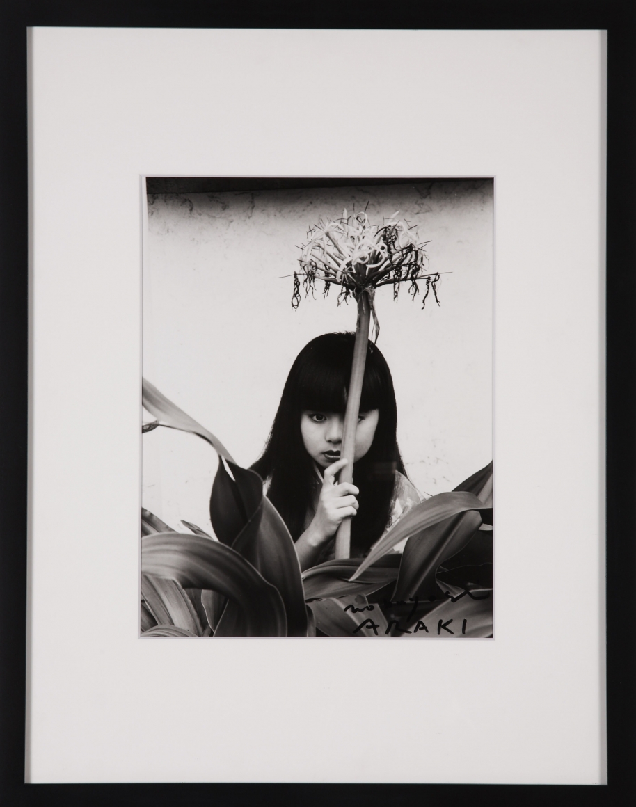 photo of a girl with a flower by nobuyoshi araki