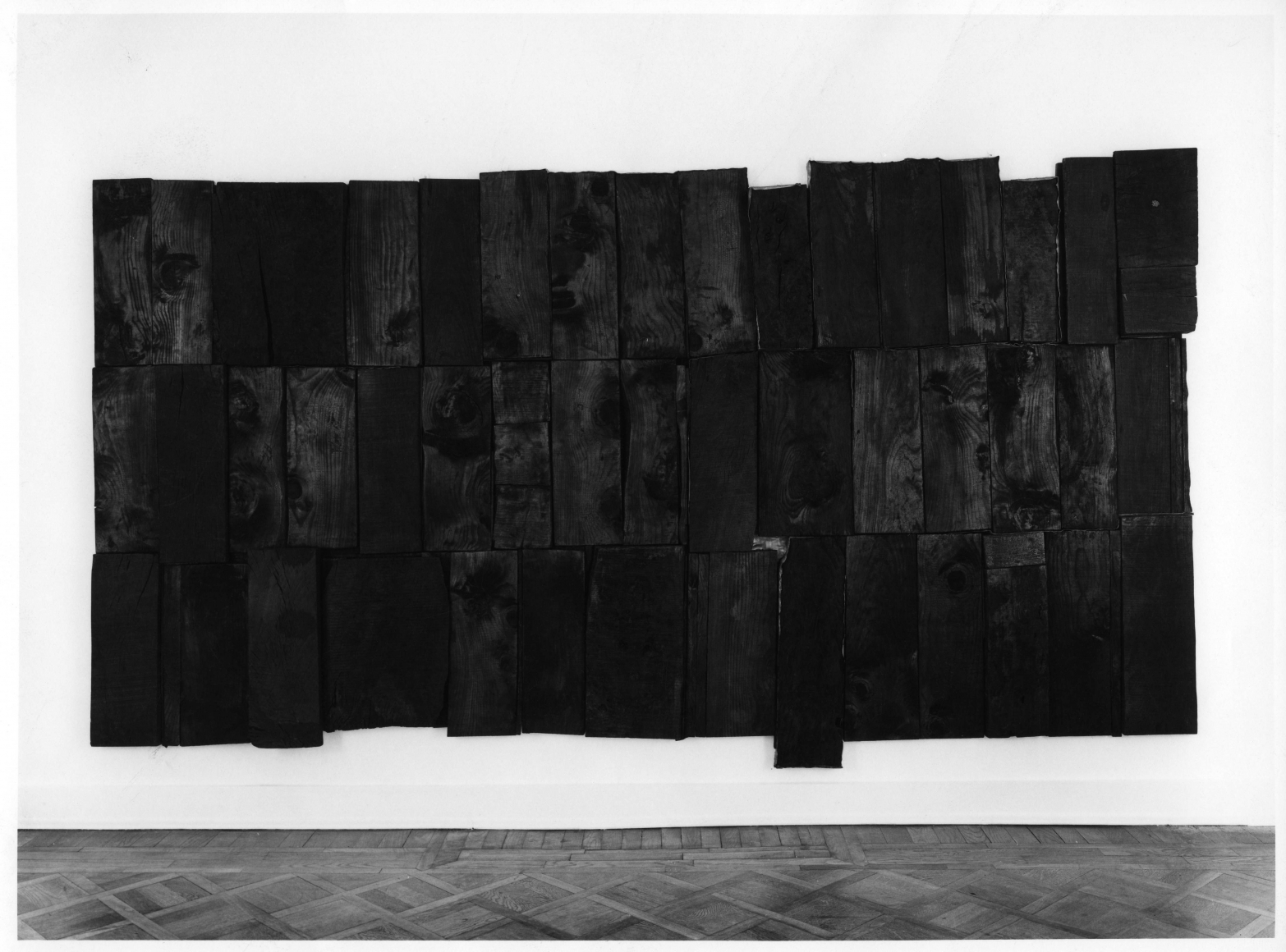 hung sculpture by pier paolo calzolari made of burnt wood panels