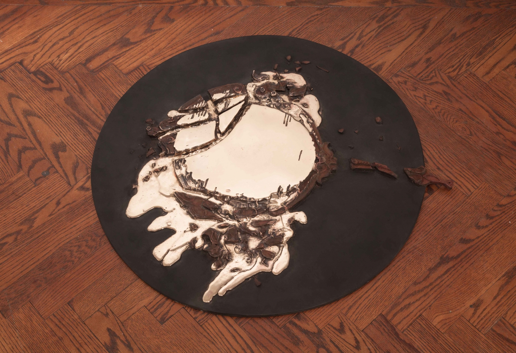 diana al-hadid circular black sculpture with beige and brown decorations