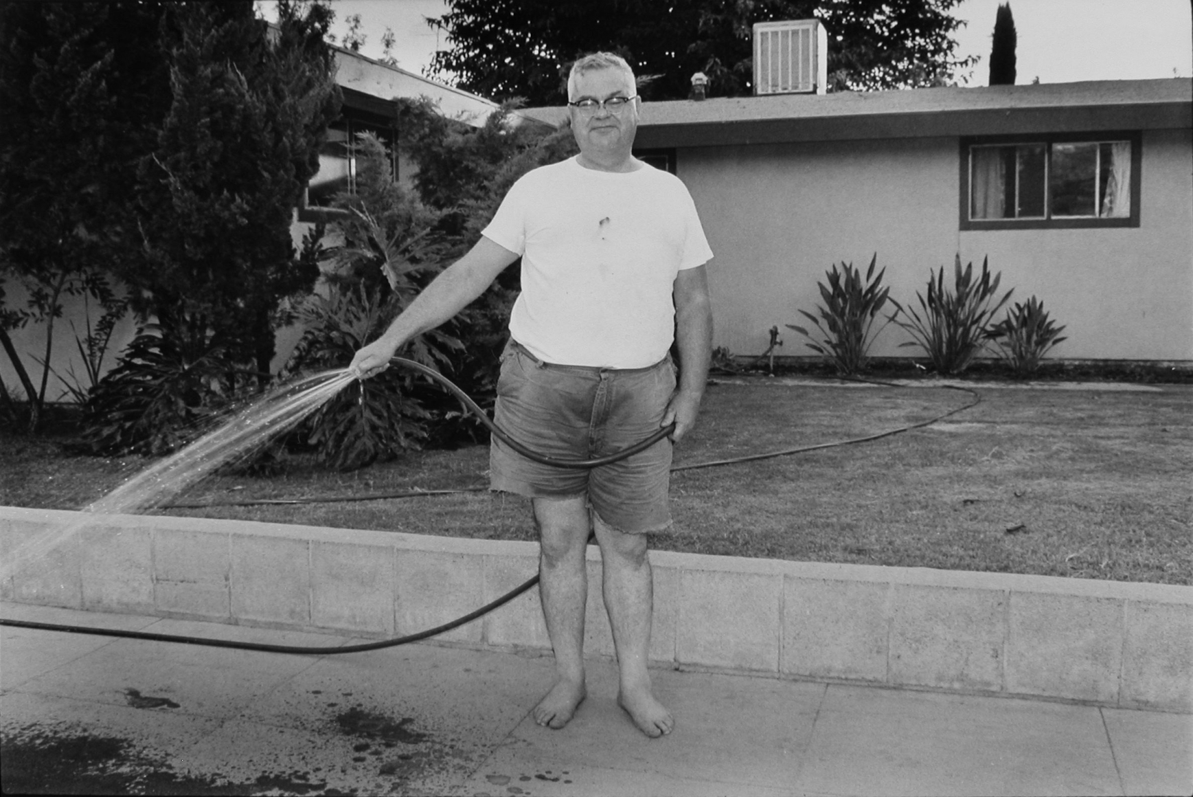 John Divola Untitled (man watering lawn), 1971–73