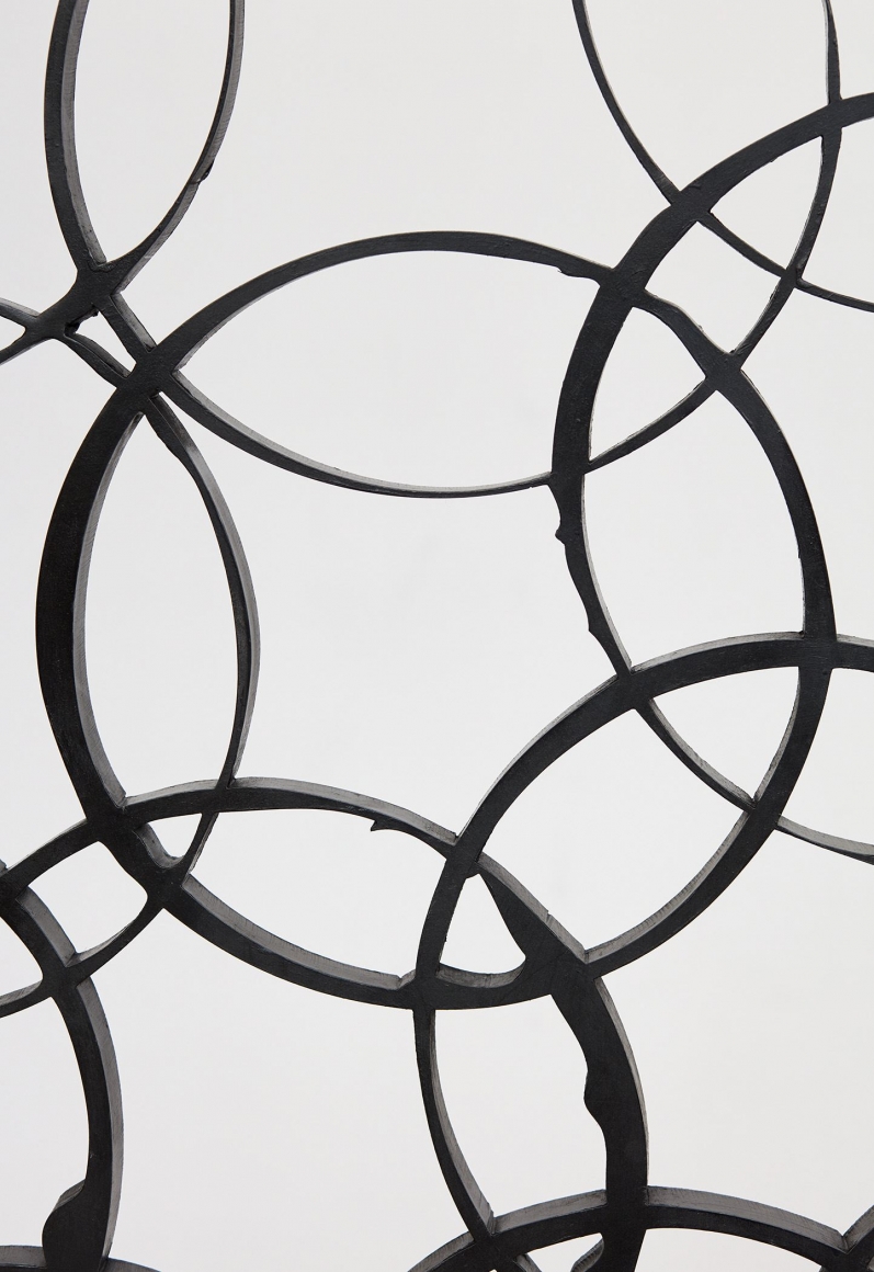 a detail of a geometric steel sculpture by anthony pearson