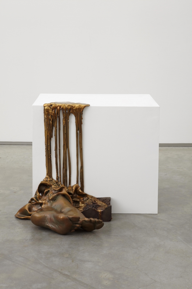 a bronze work of art that is dripping off a pedestal by Diana Al-Hadid