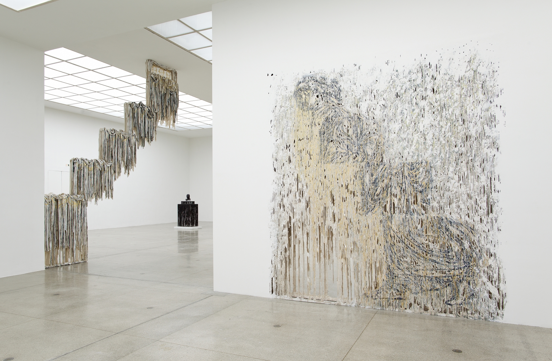 an exhibition view of sculptures and artworks by Diana Al-Hadid in a museum