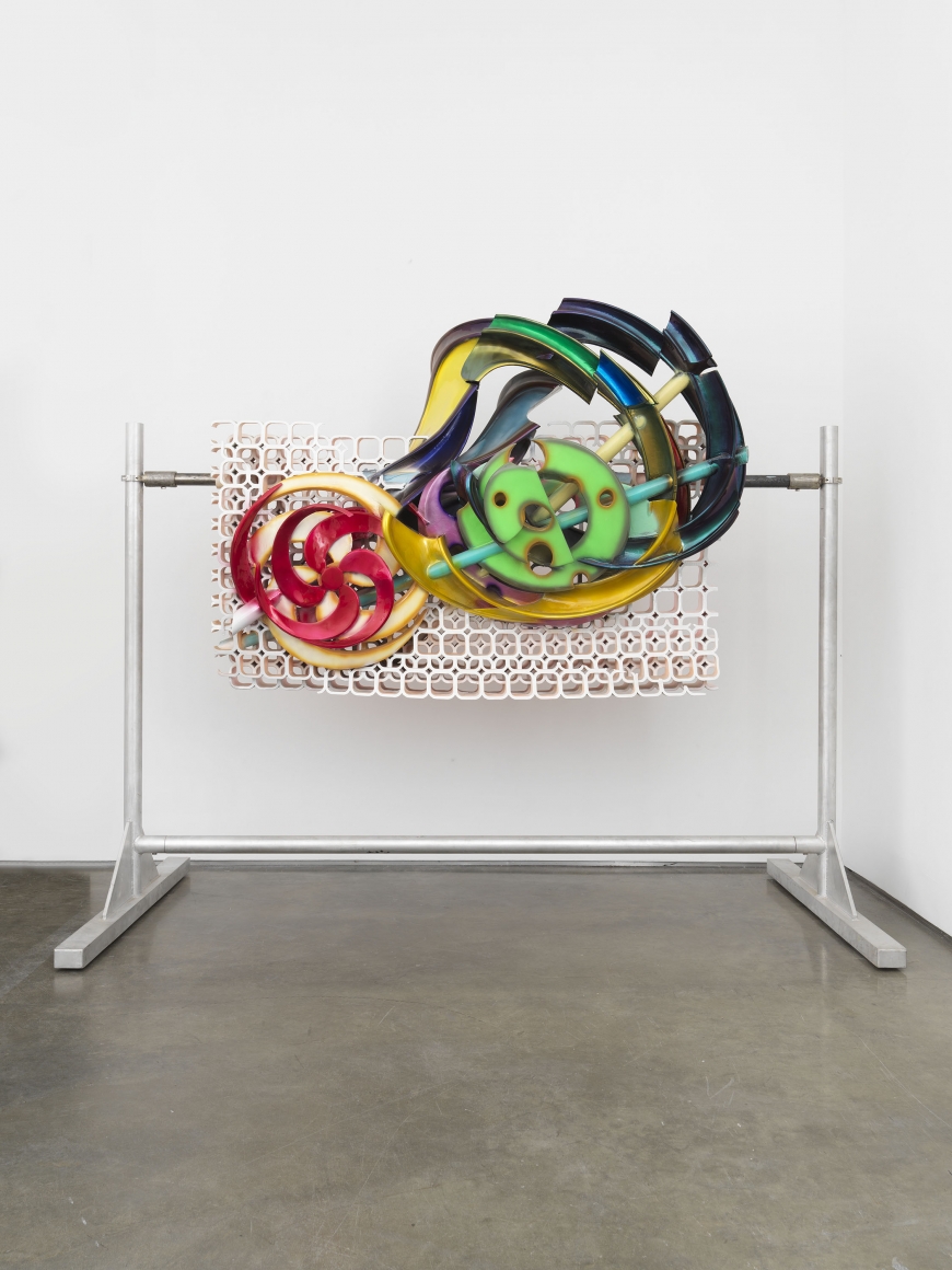 A colorful 3-d printed sculpture by Frank Stella in a contemporary art gallery