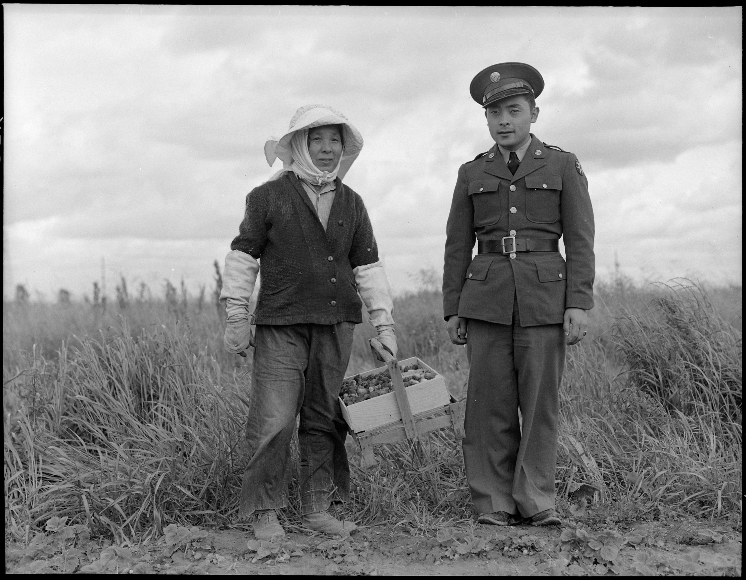 Dorothea Lange Florin, Sacramento County, California. A soldier and his mother in a strawberry field, 1942