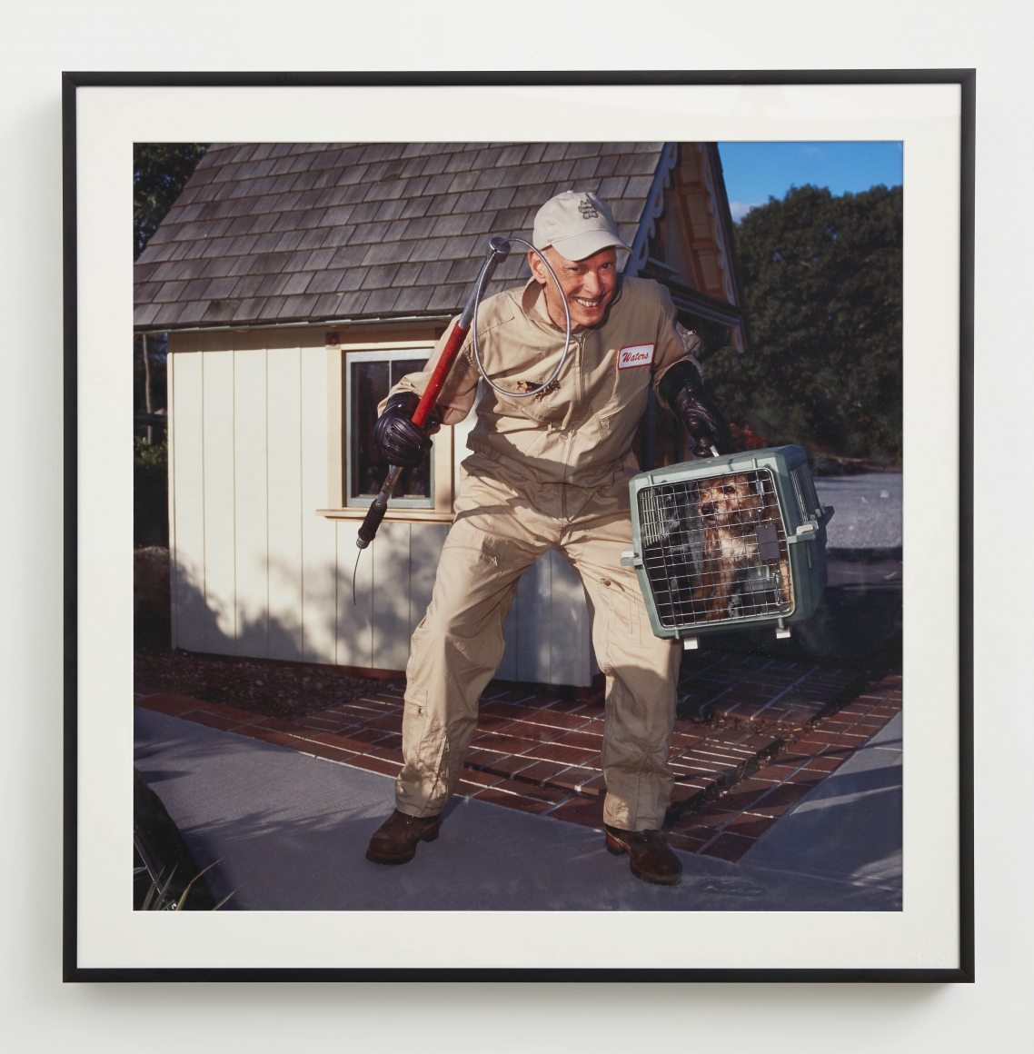 a photograph self portrait of John Waters in an exhibition in Chelsea