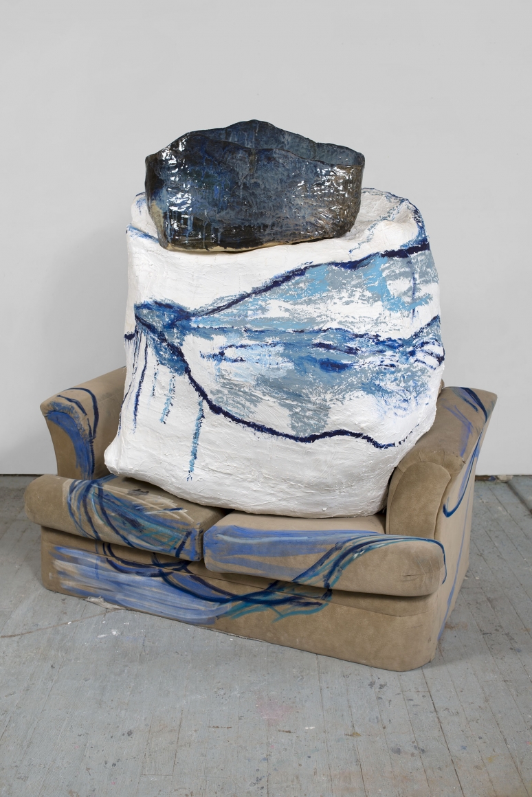 a sofa with a large ceramic on top of it by the ceramicist artist jessica jackson hutchins