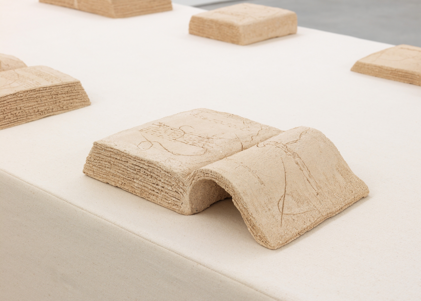 a terracotta book by italian female artist maria lai exhibited in a new york city gallery