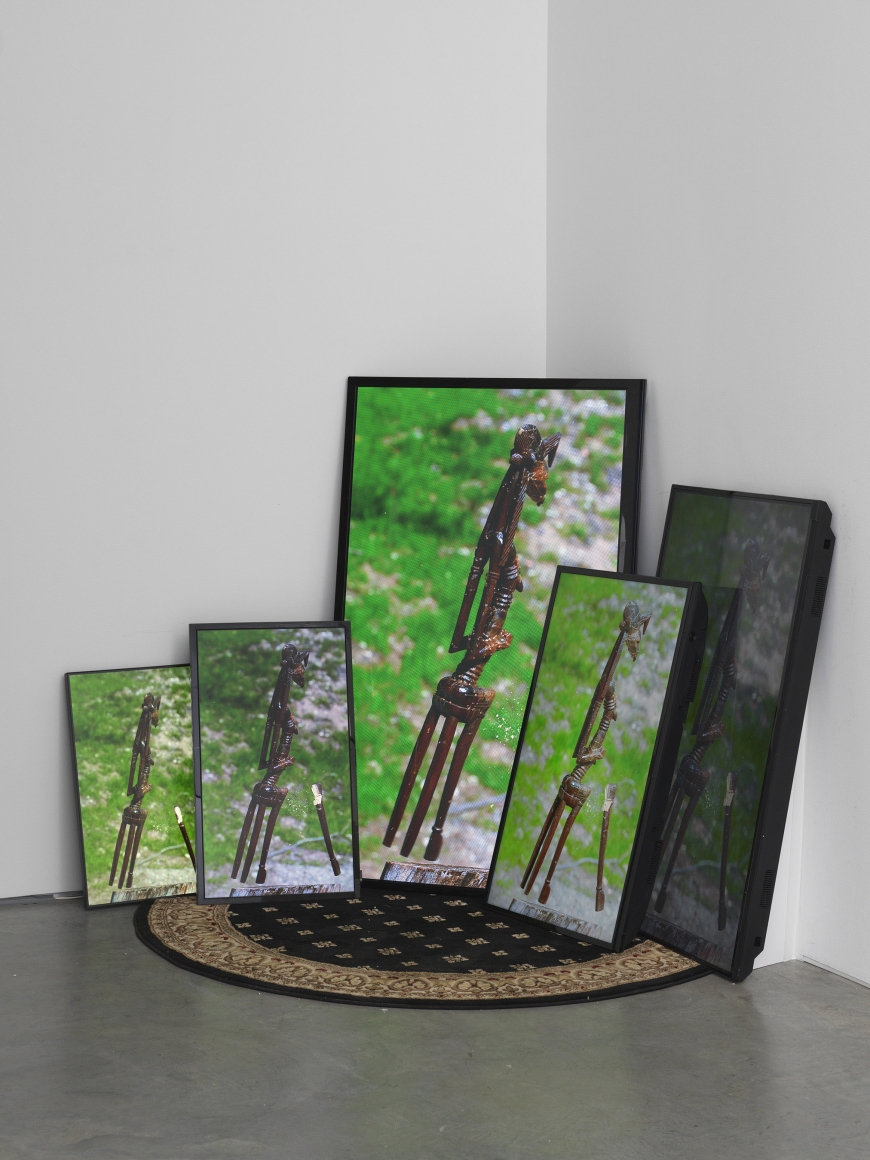 a series of photographs of an African sculpture by Sanford Biggers