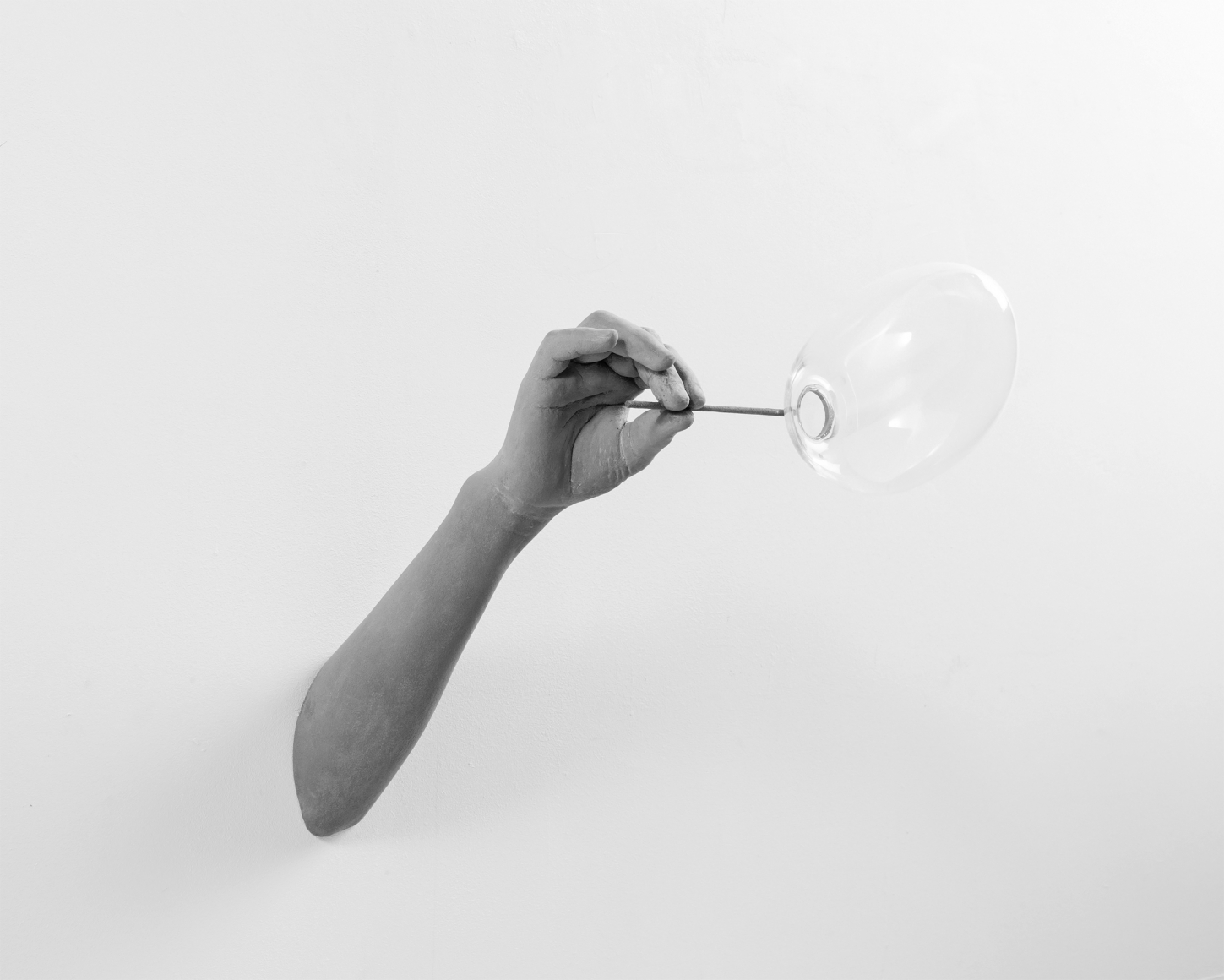 a plaster and glass grey sculpture of a bubble by Hans Op de Beeck