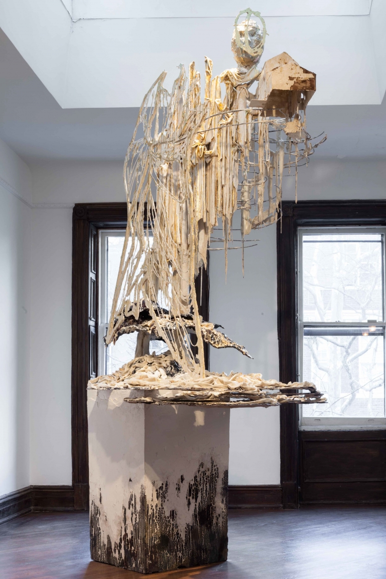 beige sculpture of a beige and white ascending figure by diana al-hadid
