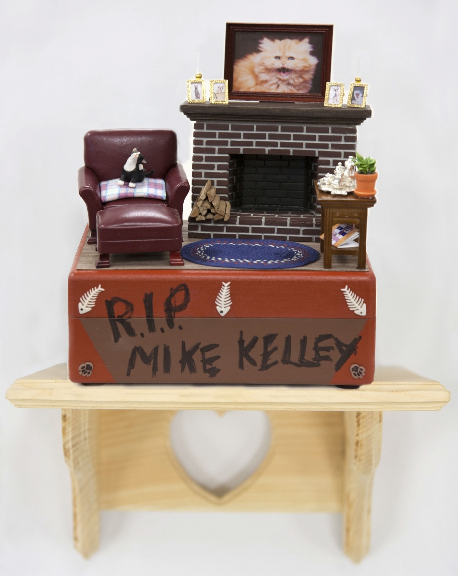 R.I.P. Mike Kelley, 2014, Hand-painted cat urn with decorative detail, clear knotty pine shelf with engraved heart detail